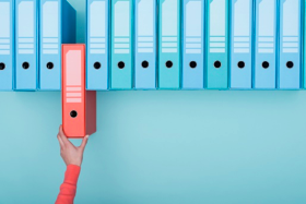 a hand picking out a binder